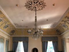 14A The spacious ballroom has a Broadwood piano as its centrepiece with hand painted crown-molded ceiling and chandelier Devon House mansion Kingston Jamaica